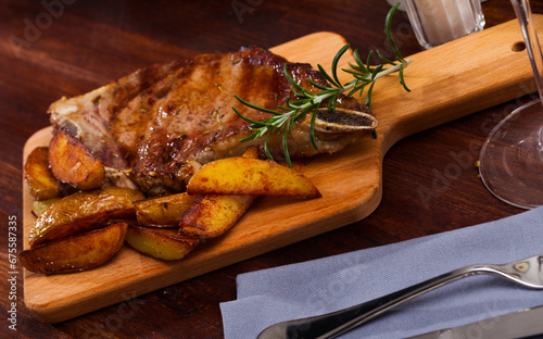 Juicy roasted entrecote served with baked potatoes and rosemary