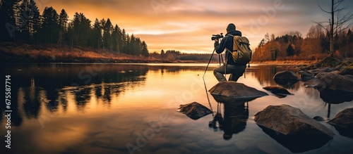 A man photographer on a beautiful lake. photo