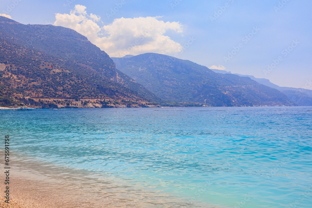 View of the mountains and the sea from Oludeniz beach, the blue lagoon. The cleanest beach with blue flag. Background