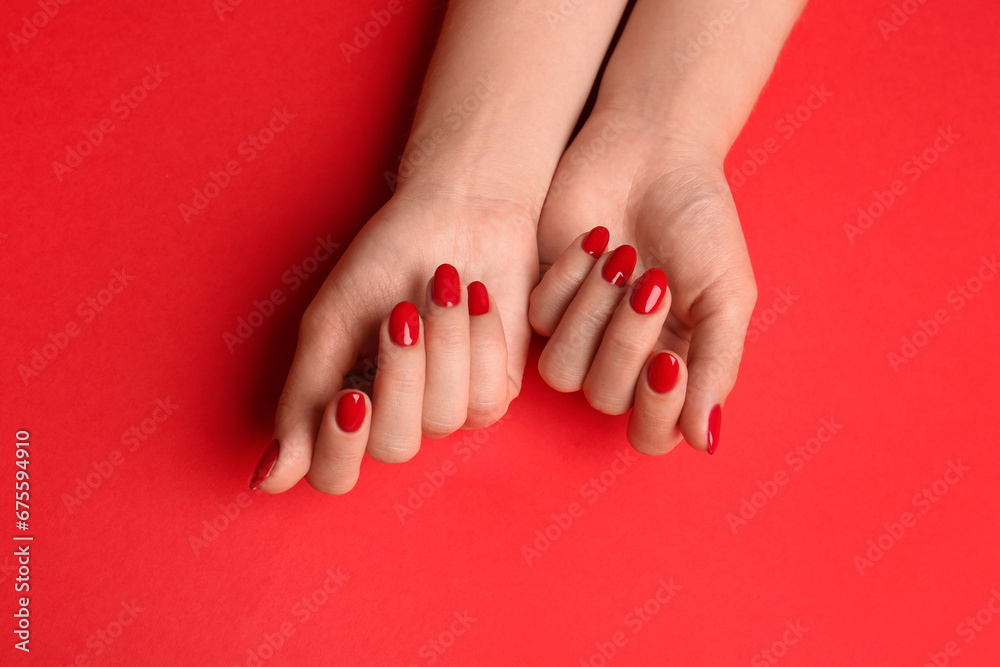 Woman with gel polish on nails against red background, top view Woman with gel polish on nails against red background, top view