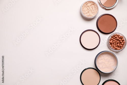 Different face powders on light background, flat lay. Space for text