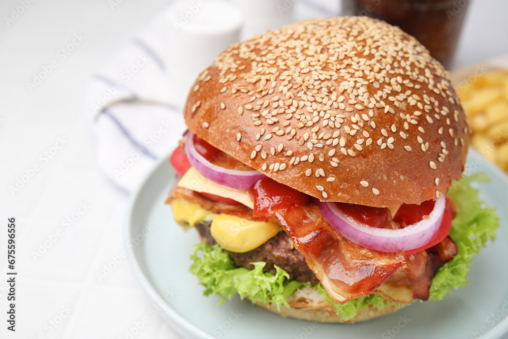 Delicious burger with bacon, patty and vegetables on white table, closeup Delicious burger with bacon, patty and vegetables on white table, closeup