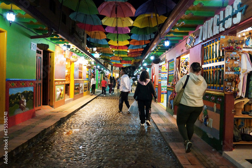 Street of the Umbrellas at night. Cobblestone street decorated with colorful umbrellas.