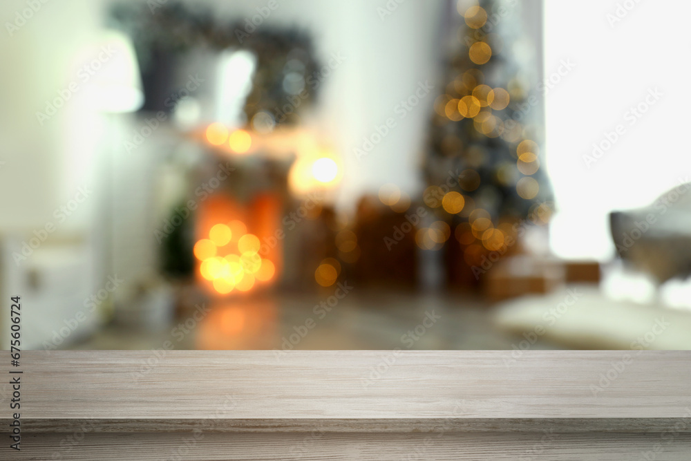 Empty wooden board in room decorated for New Year celebration, space for design Empty wooden board in room decorated for New Year celebration, space for design