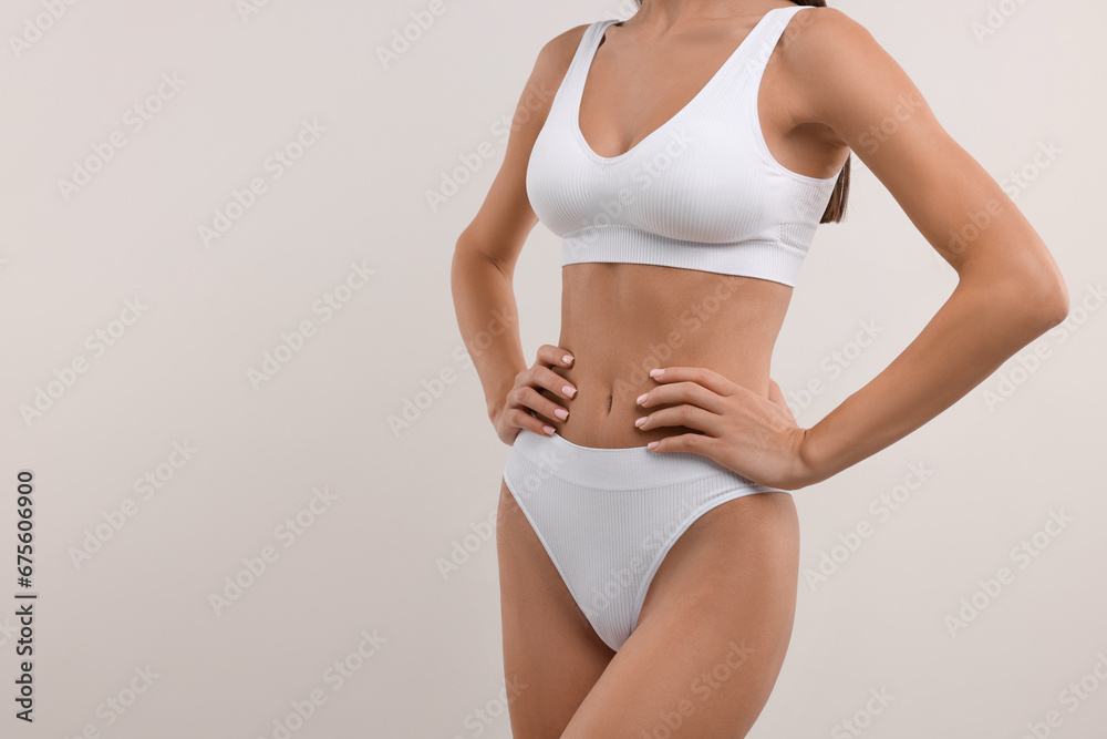 Young woman in stylish bikini on white background, closeup. Space for text Young woman in stylish bikini on white background, closeup. Space for text