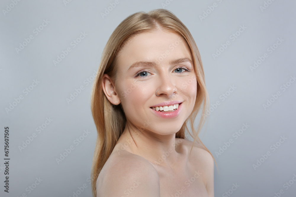 Portrait of beautiful young woman on grey background Portrait of beautiful young woman on grey background