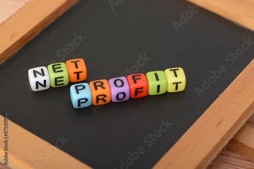 Alphabet beads with text NET PROFIT. Net profit is the amount of money your business earns after deducting all operating, and tax expenses over a given period of time photo