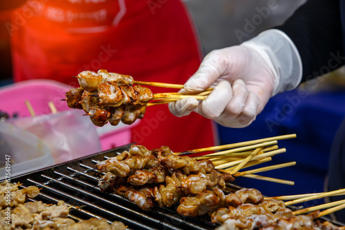 grilled pork intestines skewers  in street food market  photo