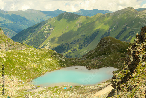 Close up on the small Sophia lake with camps on bank. Arkhyz, Caucasus, Russia