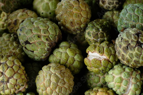 Srikaya is a plant belonging to the genus Annona which originates from tropical areas. Annona squamose. Sugar apple fruits. Blurred image of fruits.  photo