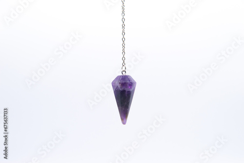 Fotografía Purple Amethyst crystal pendulum on chain isolated on white background