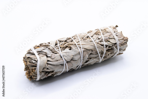 Bundle of dry white sage close-up isolated on white background. Normally used for purification, meditation and healing photo