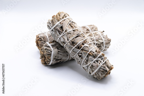 Bundles of dry white sage close-up isolated on white background. Normally used for purification, meditation and healing