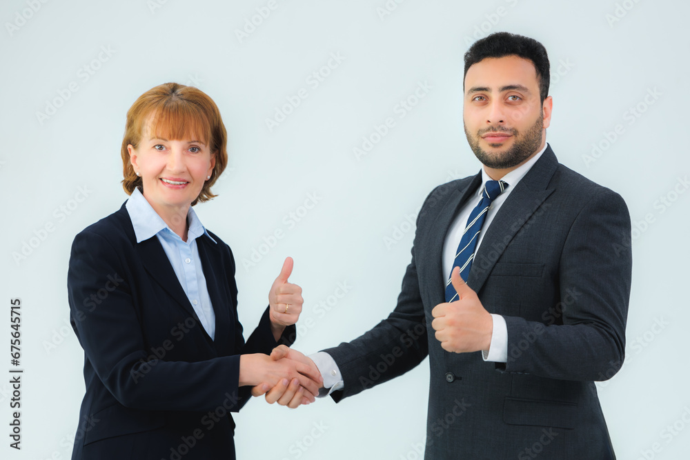 business man and business woman shaking hands in the office business man and business woman shaking hands in the office