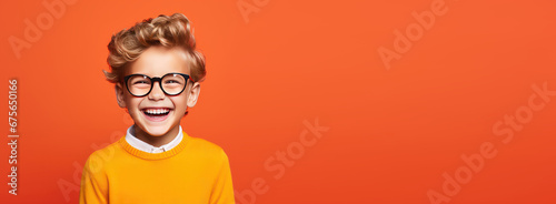 Portrait of happy kid smiling on bright colors studio background with empty copyspace, Cheerful little boy having fun photo