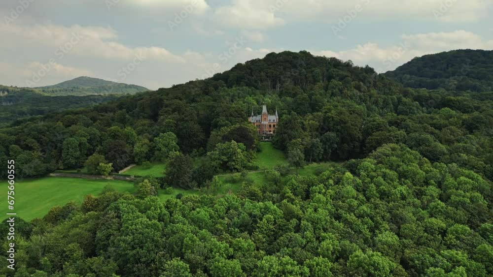 Surrounded by woodland, siting on slope hilly slope, beautiful architecture Surrounded by woodland, siting on slope hilly slope, beautiful architecture