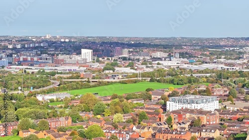 Aerial footage of the Leeds centre of Headingley, the footage shows the town centre in the background with roads and traffic, taken on a beautiful sunny day. photo