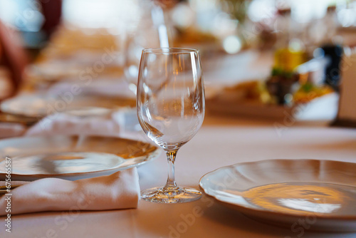 An empty wine glass on a table served for a banquet. 