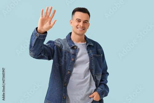 Handsome man waving hand on...