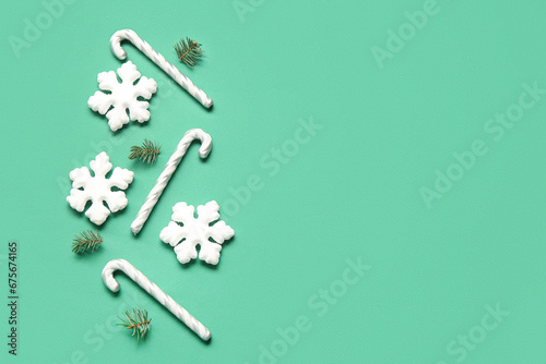 Beautiful snowflakes with fir branches and candy canes on green background