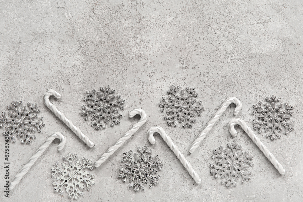 Beautiful snowflakes with candy canes on grunge grey background Beautiful snowflakes with candy canes on grunge grey background