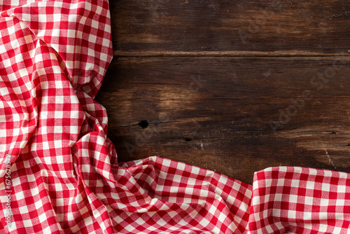 red tablecloth on wooden background