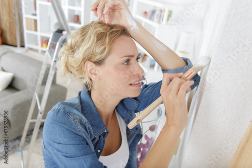 tired woman with brush in hands
