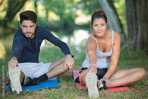 a young couple stretching outdoors