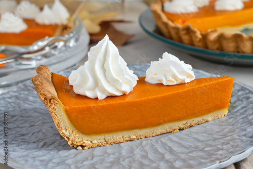 Slice of traditional pumpkin pie for Thanksgiving dinner, topped with whipped cream, generative AI