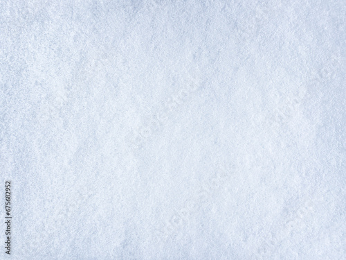 Winter background with snow patterns. Abstract background. The natural texture of snow. The surface of clean fresh snow. Panorama. Close-up view from above. New Year's background. Copy space