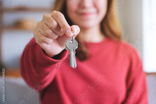 Closeup image of a woman holding the keys for real estate concept
