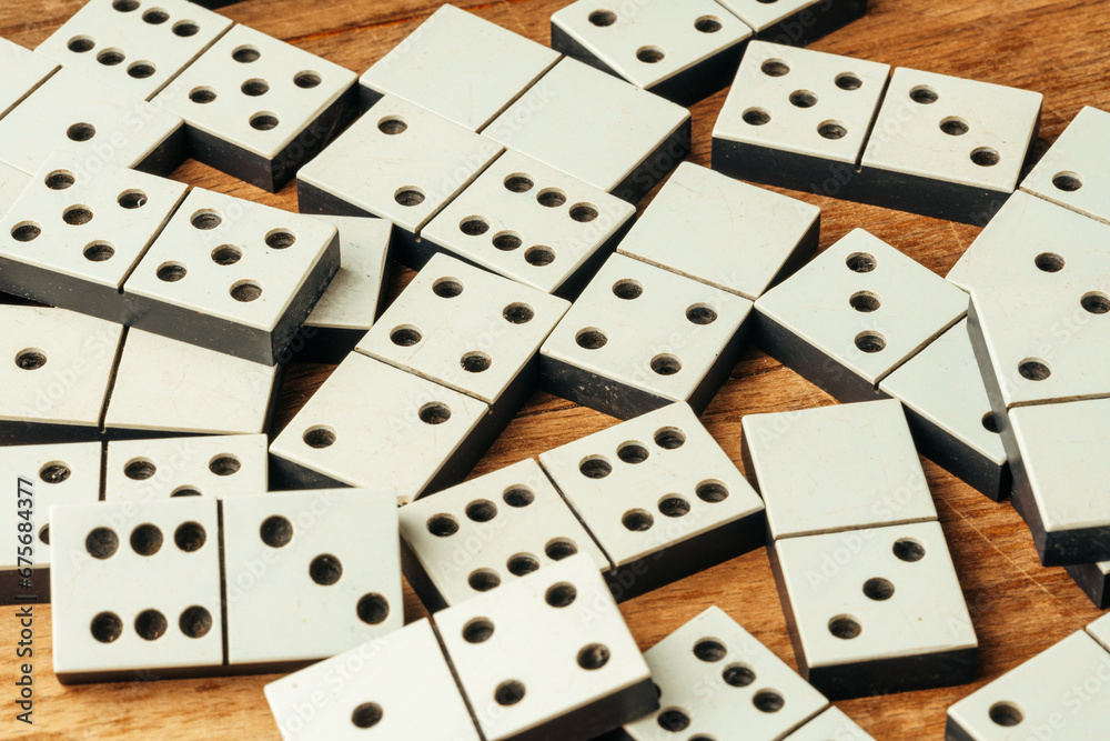 Domino game on brown wooden background close up
