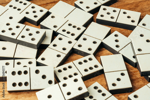 Domino game on brown wooden background close up