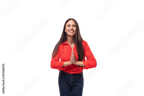 portrait of a charming young model woman with straight black hair dressed in a red blouse tucked into trousers