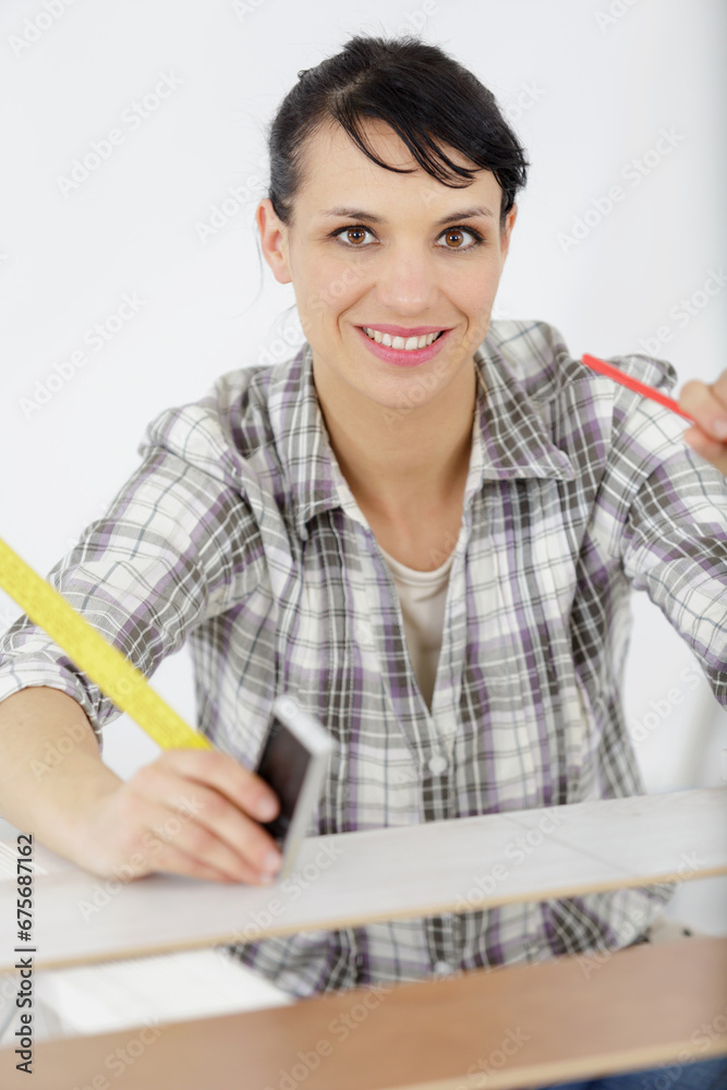 portrait of female carpenter standing with work tool portrait of female carpenter standing with work tool