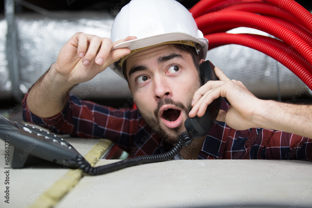 shocked young man technician on the phone shocked young man technician on the phone