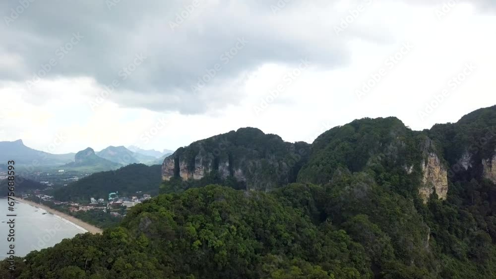Overhead slow reveal of the white sandy beaches of Krabi beaches, facing the Andaman Sea in the South of Thailand. Overhead slow reveal of the white sandy beaches of Krabi beaches, facing the Andaman Sea in the South of Thailand.