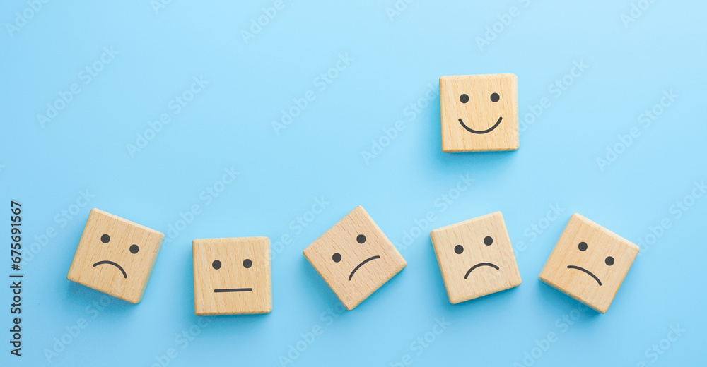 Wooden blocks with the happy face smile face symbol on blue background, evaluation, Increase rating, Customer experience, satisfaction and best excellent services rating concept Wooden blocks with the happy face smile face symbol on blue background, evaluation, Increase rating, Customer experience, satisfaction and best excellent services rating concept