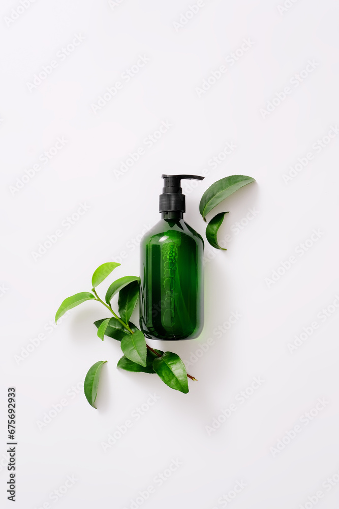 Top view of green homemade shampoo bottle with green tea extract on a