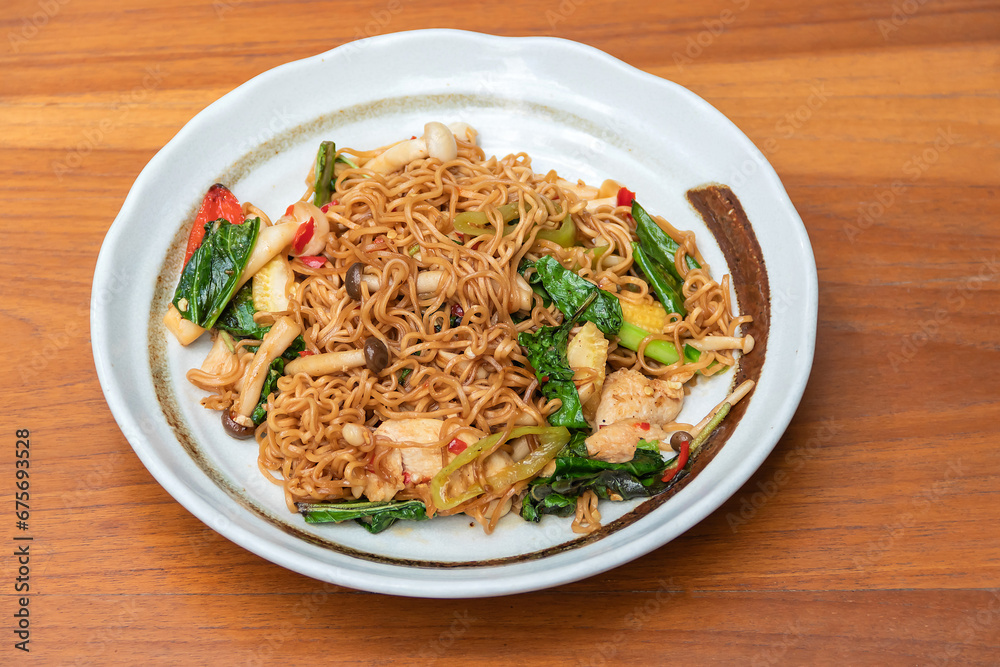 Spicy Stir Fried Instant Noodle with Seafood and basil Thai food style.