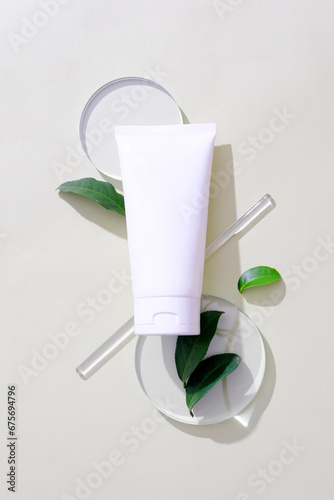 Wallpaper Mural Close-up of a cosmetic tube placed on two glass platforms, green tea leaves decorated around, and a glass rod. Exquisite mockup for natural cosmetics advertising. Torontodigital.ca