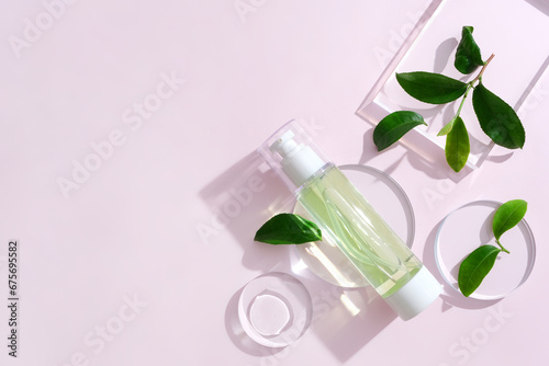 Wallpaper Mural Hair spray bottles with green tea extract are displayed with fresh green tea leaves and transparent glass podiums on a pastel background. Mockup for vegan cosmetics advertisement. Torontodigital.ca