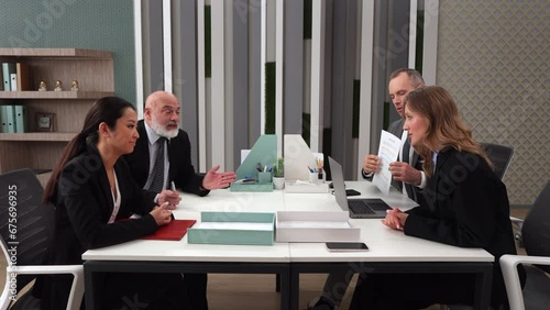 Tense business partners sitting in company office building and dispute about work, signing contract agreement paper. Company corporate meeting. Tensely business people office workers lawyers investors