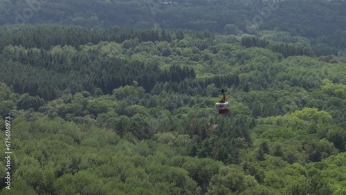 Aerial view of cable car in the mountains with forest