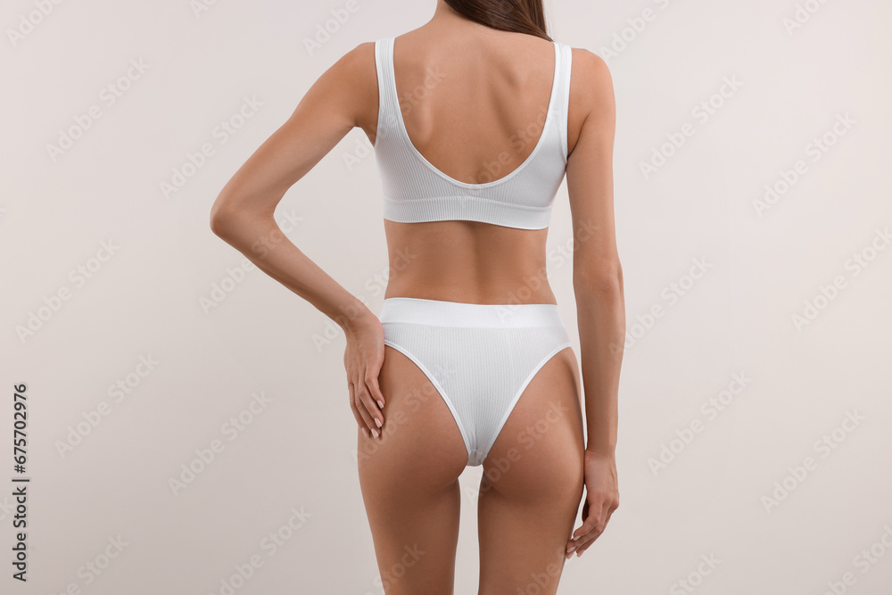 Fototapeta premium Young woman in stylish bikini on white background, closeup