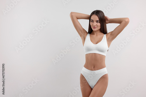 Young woman in stylish bikini on white background © New Africa