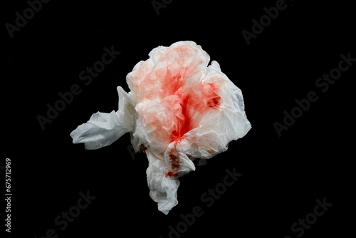 white tissue with blood clots with dark background. white tissue used to wipe blood from wounds