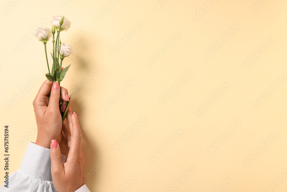 Woman with eustoma flowers on beige background, top view. Space for text Woman with eustoma flowers on beige background, top view. Space for text