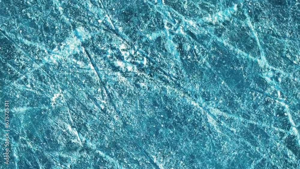 Video of spinning in slow motion on blue ice at a skating rink. View from above. Video of spinning in slow motion on blue ice at a skating rink. View from above.