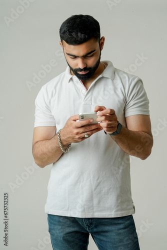 young indian stylish men using phone